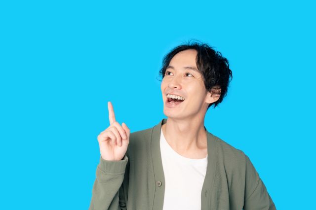 上を指さす男性
